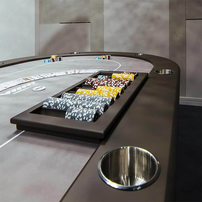 Professional Vismara Desire Poker Table setup with multicoloured poker chips and sleek grey playing surface in a modern gaming environment.