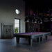 Purple felt Vismara Desire pool table in an industrial-style room, featuring contemporary cue storage with neon accents and high-tech design.