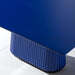 A close-up of the Vismara Egeo Table’s fluted resin leg in a striking blue finish, showcasing its modern elegance.