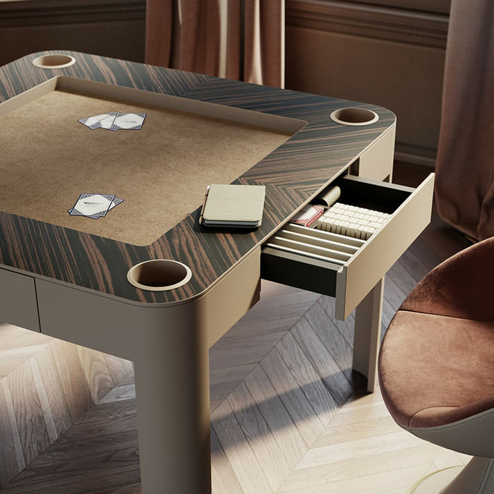 Multifunctional Vismara Enigma game table with open drawer revealing Mahjong tiles, card deck, and scorepad – stylish setup for card and board games.