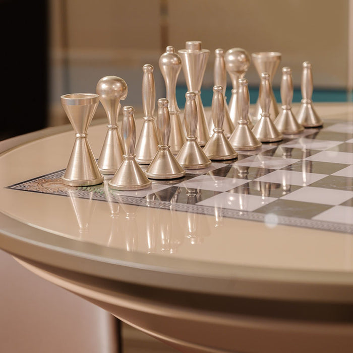 Vismara Goemon Chess Table in a bold contemporary lounge with deep red walls, striped flooring, and velvet chairs, combining luxury play with dramatic interior design.