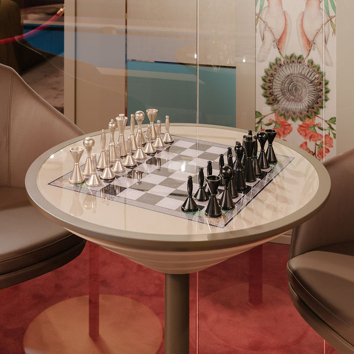 Studio image of the Vismara Goemon Chess Table with a tall round pedestal base and premium chessboard top, blending modern lines with elegant golden accents.
