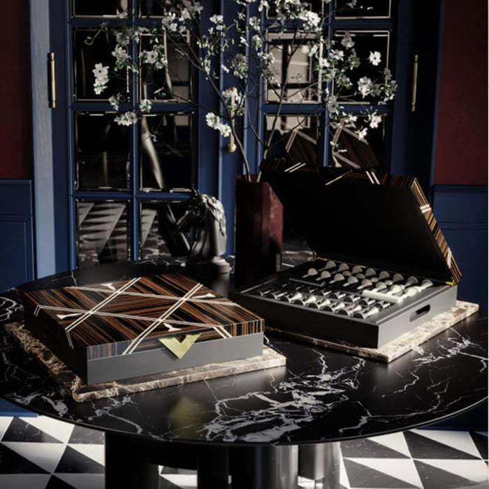 Vismara Goemon luxury chess set with closed and open view, highlighting precision-crafted black and ivory pieces in a high-gloss wooden presentation box.