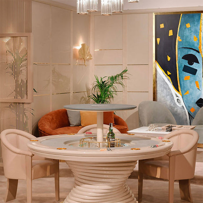 Front-facing view of the Vismara Mirabilia Poker Table with ivory lacquered spiral base, glossy finish, and circular playing surface with metallic cup holders and poker chips.