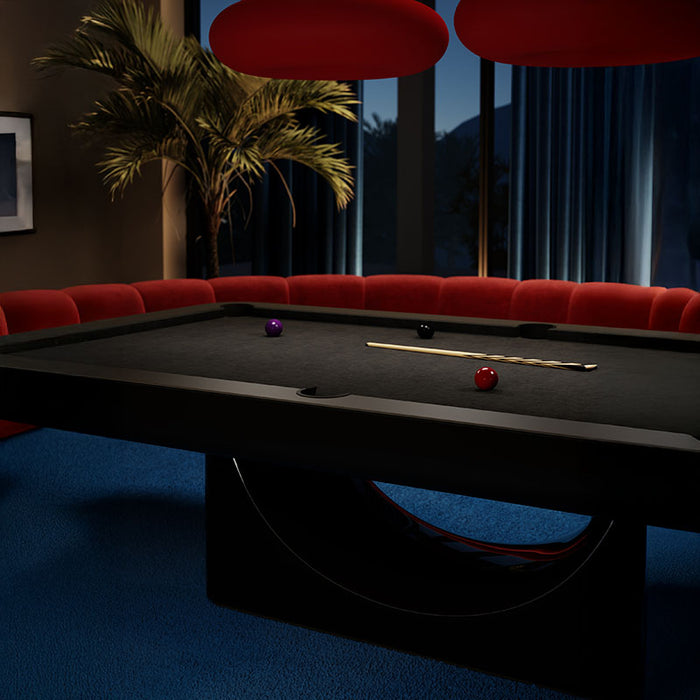 The Vismara Mono Pool Table in a luxurious dim-light setting, highlighting its sleek carbon fibre finish.