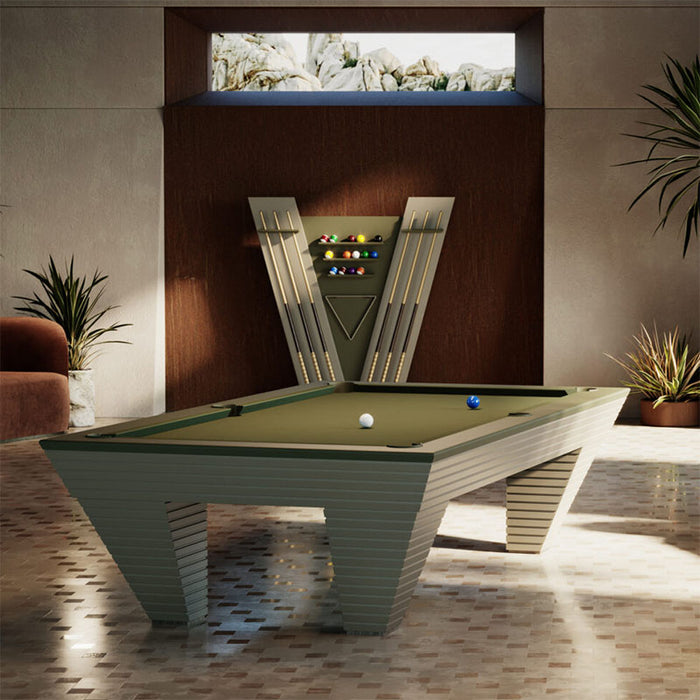 Elegant game room featuring the Vismara Newde Cue Rack and matching pool table surrounded by greenery and luxury seating.