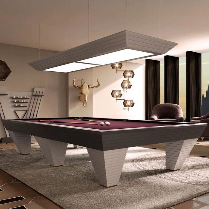 The striking purple-cloth Vismara Newde Pool Table set under a modern rectangular light, surrounded by plush seating and artistic wall décor.