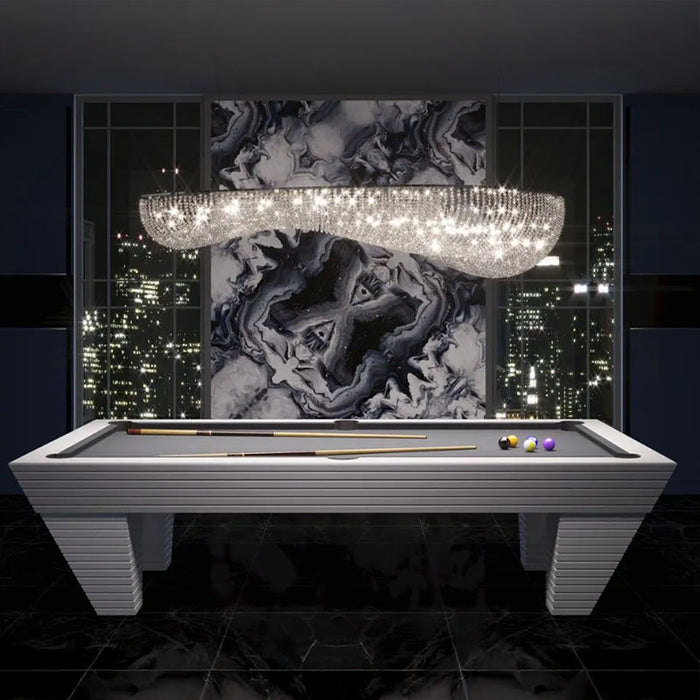 The sleek grey Vismara Newde Pool Table paired with contemporary lighting and a bold black-and-white marble design, creating a dramatic focal point.