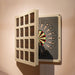Angled view of the Vismara Nido Dartboard Cabinet opening to reveal a luxury dartboard behind its stylish cream and walnut grid door design.