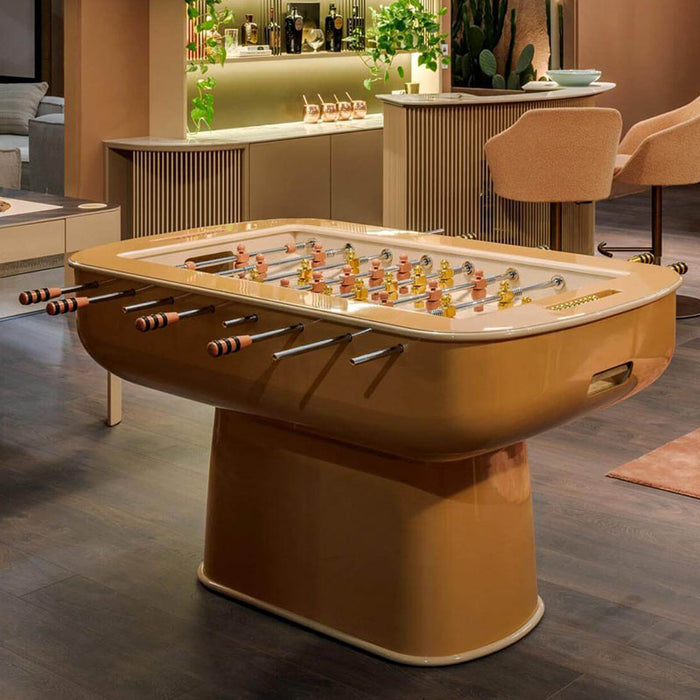 Caramel-toned Oskar Foosball Table in a chic bar setting, surrounded by muted tones and warm lighting.