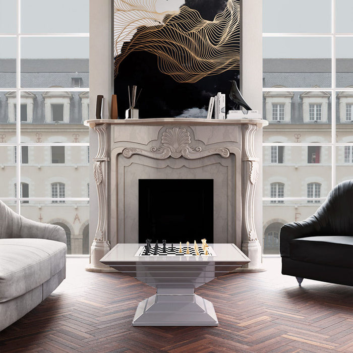 Vismara Scaccomatto Chess Table in a regal interior with ornate fireplace, classic artwork and Parisian-style windows, offering a timeless luxury ambience.