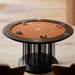 Detail view of the Vismara Shanghai Poker Table with circular design, elegant black base and rich terracotta top, styled with chips and cards for luxury gameplay.