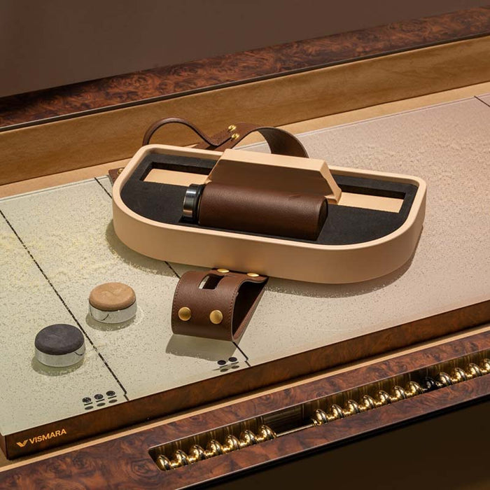 Detailed shot of Vismara Flume shuffleboard accessories with leather‑trimmed case and polished pucks on a refined playing surface – designer game set for luxury interiors.