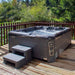 Wellis Valencia Hot Tub installed on wooden decking with lush forest views, blending spa luxury with nature escapes.