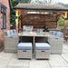 Front view of the Wentworth 10 Seater Cube Dining Set in a patio area, featuring a glass-topped dining table with plush grey cushions on rattan chairs, ideal for al fresco dining.