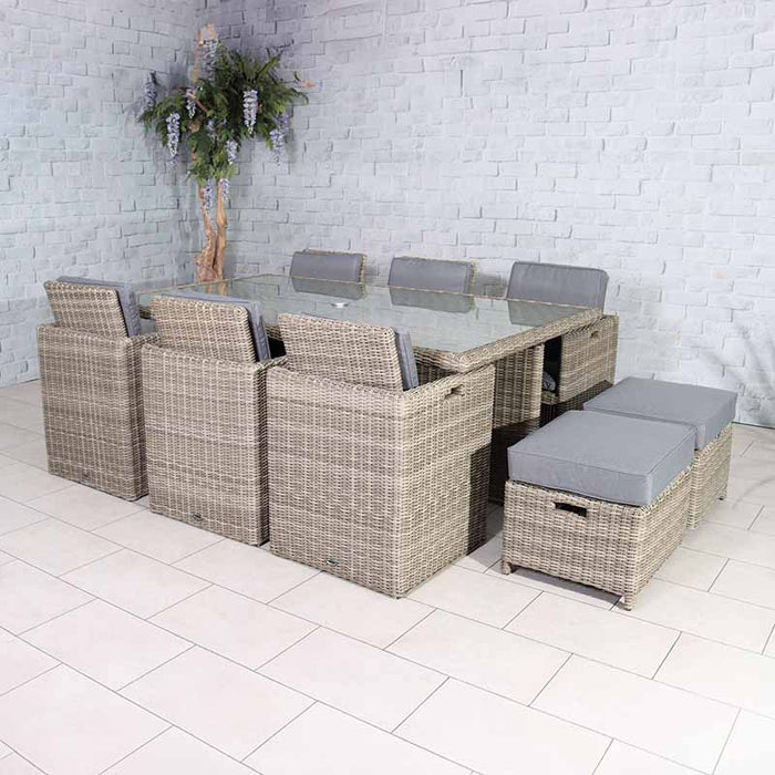 Indoor setup of the Wentworth 10 Seater Cube Dining Set with a glass-topped table and rattan chairs, offering a stylish dining solution.