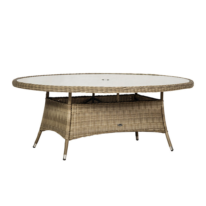 An angled view highlighting the glass-top oval table of the Wentworth 6 Seater Ellipse Imperial Dining Set, showing its durable rattan weave and sleek design.