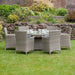 A full garden scene featuring the Wentworth 6 Seater Round Carver Dining Set, offering a picturesque setting for outdoor dining.