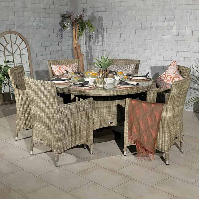 A top-down perspective of the Wentworth 6 Seater Round Carver Dining Set, featuring a well-dressed table with plates, glasses, and decorative elements.