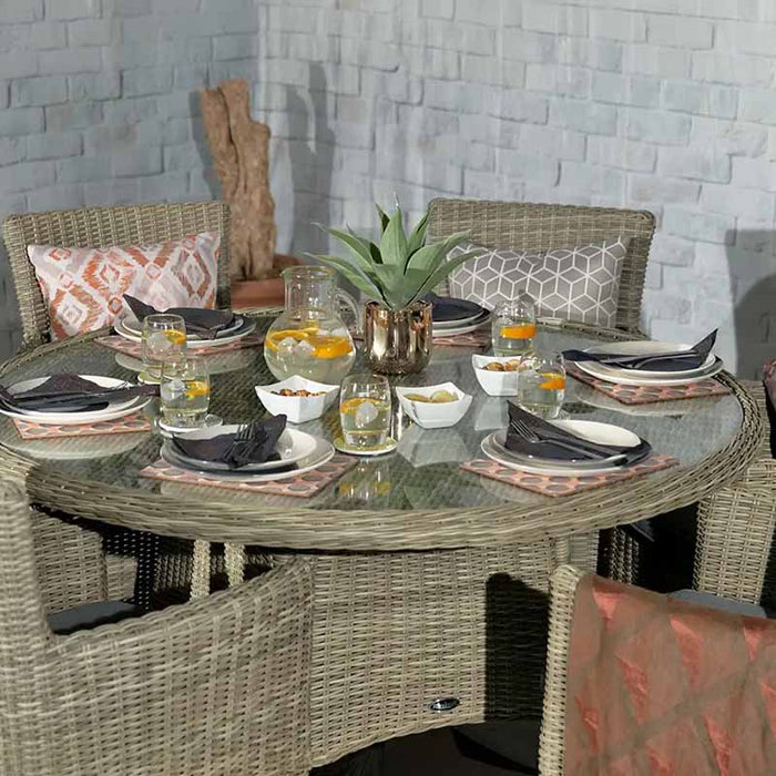 An image showing the entire Wentworth 6 Seater Round Carver Dining Set, complete with tableware, decor, and cushions, perfect for alfresco dining.