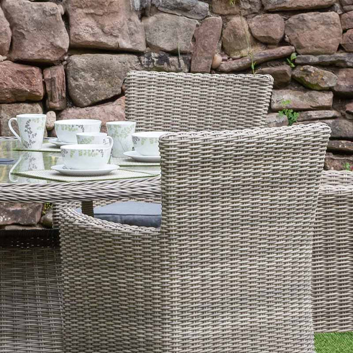 A lifestyle image of the Wentworth 6 Seater Round Carver Dining Set, beautifully arranged with cups and plates, perfect for outdoor gatherings.