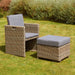 Single chair and ottoman from the Wentworth 8 Seater Cube Dining Set, placed in a garden, perfect for relaxing outdoors.