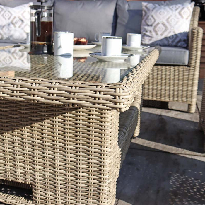 Close-up of the Wentworth 8 Seater Deluxe Corner Dining Set's tempered glass top, showcasing the intricate rattan weave and elegant table setting.