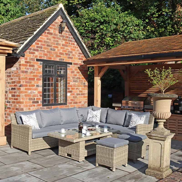 Wentworth 8 Seater Deluxe Corner Dining Set placed in a charming outdoor setting, featuring a comfortable and spacious design for family gatherings.