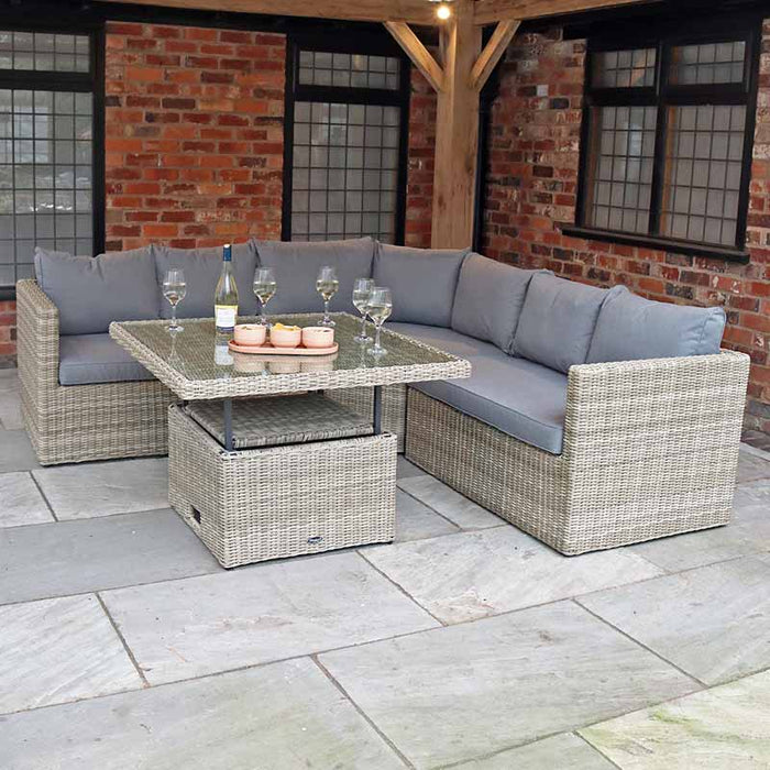 Front view of the Wentworth Adjustable Corner Lounge Set, showcasing the adjustable table with a glass top and stylish grey cushions.