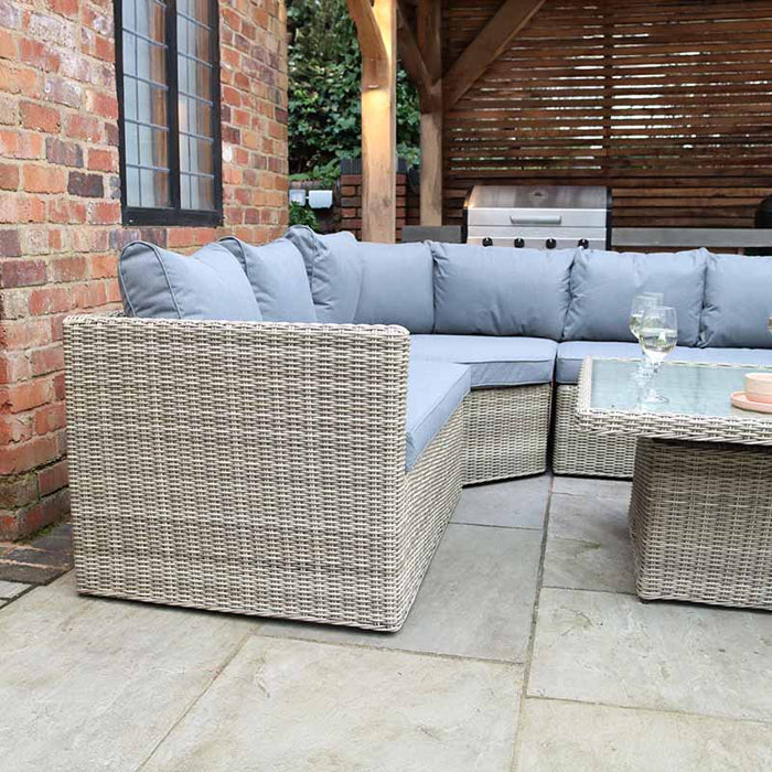 The Wentworth Adjustable Corner Lounge Set in an outdoor scene, showcasing the modular design and comfortable seating arrangement.