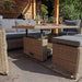 Outdoor setup of the Wentworth Deluxe Sofa Dining Set under a pergola, featuring a glass-top dining table and cushioned rattan furniture.