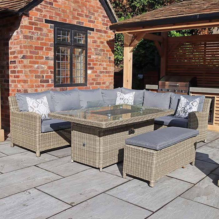 Evening view of the Wentworth Fire Pit Dining & Lounge Set with Rectangular Table, highlighting a cosy outdoor dining experience.