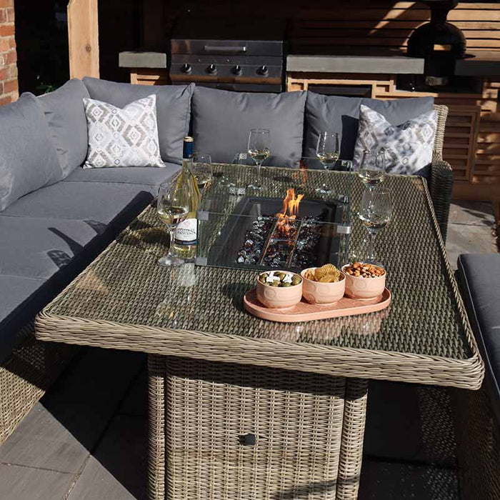 Wentworth Fire Pit Dining & Lounge Set with Rectangular Table, showcasing a comfortable rattan sofa set in a contemporary outdoor space.