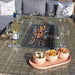 Close-up of the Wentworth fire pit table with snacks and wine, creating a cosy and inviting atmosphere for outdoor dining.