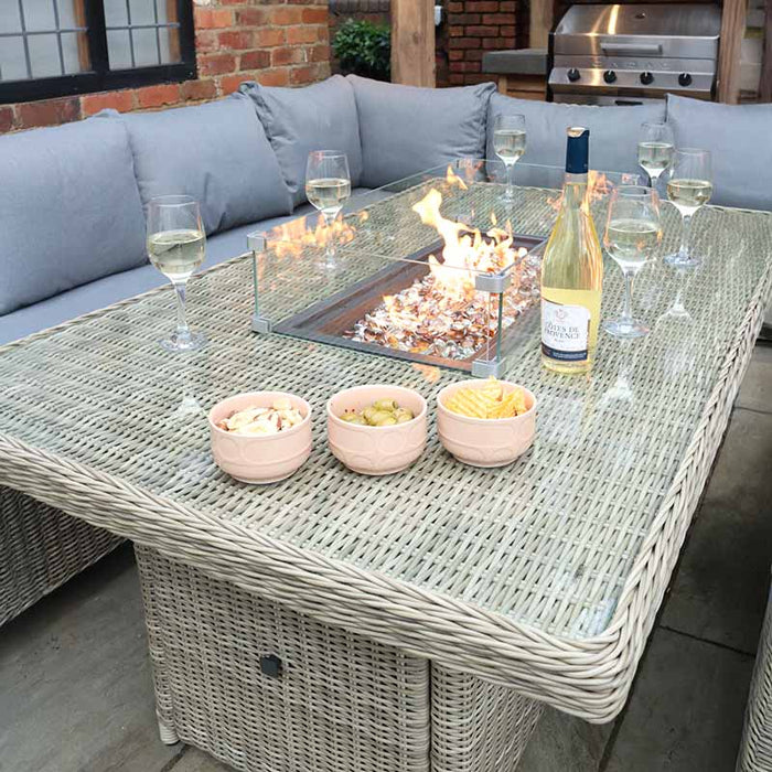 Close-up of the Wentworth Fire Pit Dining & Lounge Set with Rectangular Table, featuring a cosy fire pit and stylish rattan design in a backyard setting.