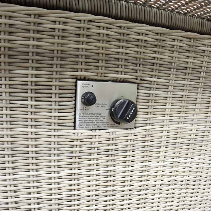 Close-up of the control panel on the Wentworth Fire Pit Corner Dining & Lounge Set's rectangular table, featuring electronic ignition and flame adjustment.