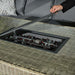 Close-up of the fire pit within the Wentworth Fire Pit Corner Dining & Lounge Set's rectangular table, showcasing the tempered glass top and fire stones.