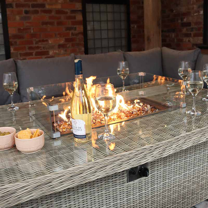 Evening view of the Wentworth fire pit table with wine and snacks, highlighting the warm and inviting setting for outdoor entertaining.