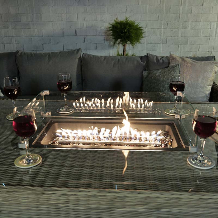 Wentworth Fire Pit Dining & Lounge Set with Rectangular Table under soft lighting, perfect for evening gatherings.