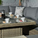 A setup for coffee on the Wentworth fire pit table, with cups and macaroons, highlighting the versatility of the dining area.