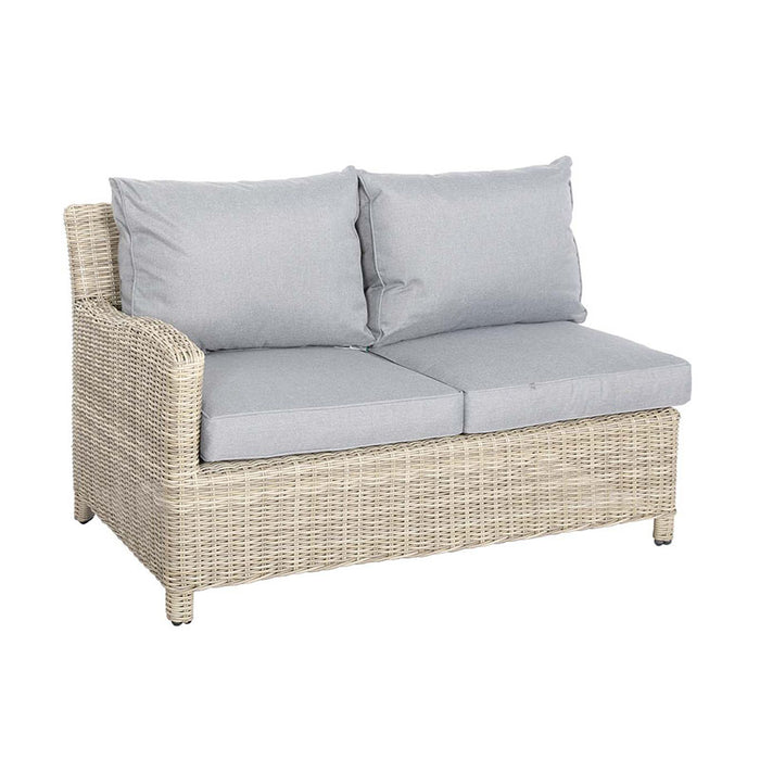 Side view of the Wentworth rattan sofa, showcasing its comfortable cushions and stylish wicker design.