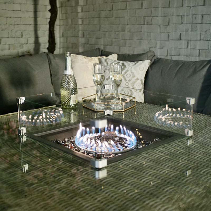 Glowing fire pit on the Wentworth Fire Pit Dining Set’s square table, creating a warm and inviting atmosphere for evening relaxation.