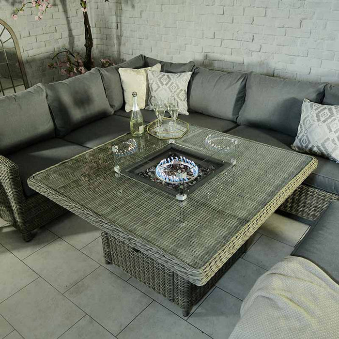 Wentworth Fire Pit Dining & Lounge Set with square table, featuring a glowing fire pit and sophisticated outdoor seating.