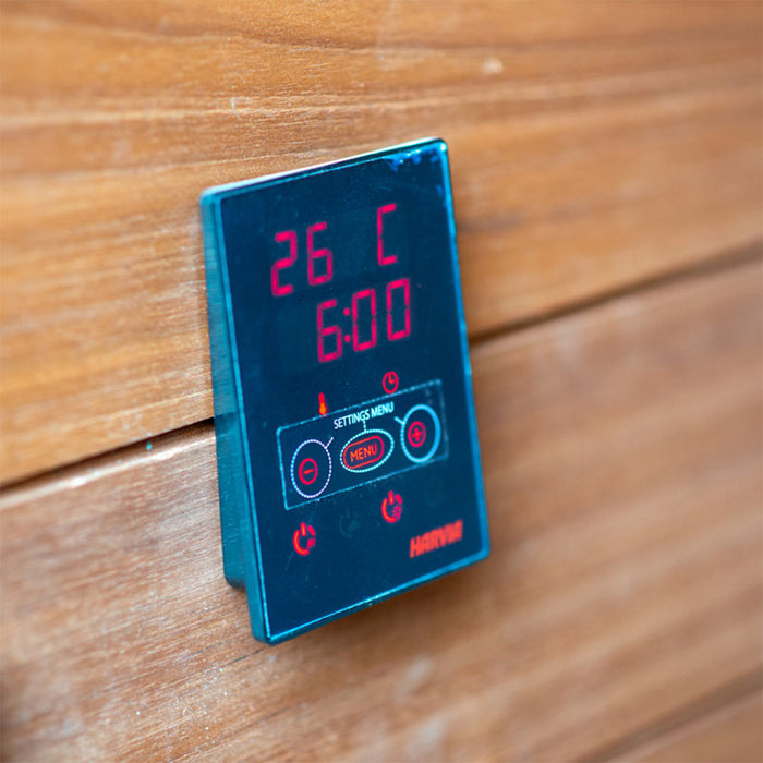Woodnest Lucia 2 Person Outdoor Sauna digital control panel mounted on the timber wall for convenient sauna temperature and timer settings.