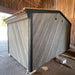 Woodnest Maria 2-4 Person Outdoor Sauna rear exterior with grey diagonal timber cladding and dark wood trim.
