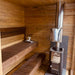 Woodnest Nora 3-4 Person Outdoor Sauna interior with tiered timber benches and Harvia wood-burning sauna heater with chimney.