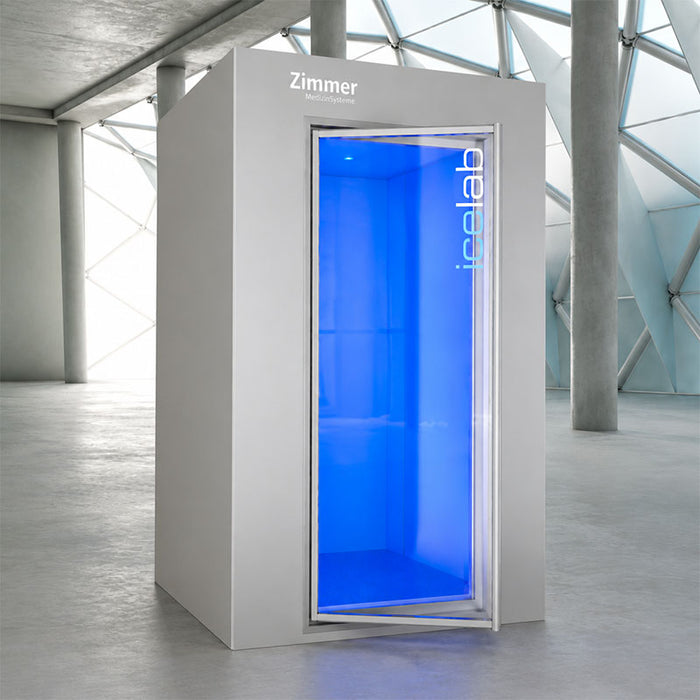 Zimmer VIP+ Cryotherapy Chamber with open glass door in a modern clinical setting, featuring a spacious whole-body cryotherapy cabin with blue illuminated interior for professional cold therapy and recovery treatments.